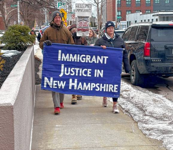 (Above and below) Faith leaders and immigrant advocates march in front of the federal Immigration and Customs Enforcement field office in Manchester to show solidarity with immigrants in response to the Trump administration’s executive orders on deportation.