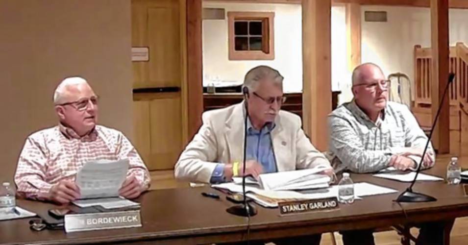 From left, Bernardston Selectboard members Ken Bordewieck, Stanley Garland and Brian Keir during Annual Town Meeting on Monday at The Farm Table’s events barn.