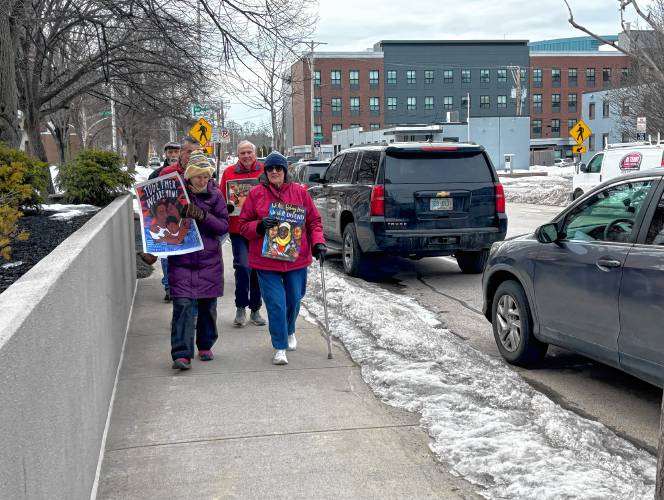Faith leaders and immigrant advocates march in front of the ICE field office in Manchester on Tuesday to show solidarity with immigrants in response to the Trump administration’s executive orders on deportation.