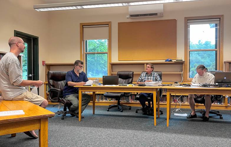 Warwick Town Clerk John Paganetti, left, speaks with the Warwick Selectboard and Town Coordinator David Young last week about scheduling a special election for Oct. 23.