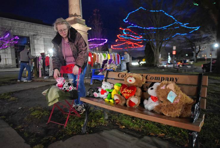 Sandra Beebe’s daughter, Alicia Cross of Greenfield, helps her mother put hats, scarves, gloves, blankets, stuffed animals and other garments on the Greenfield Common for anyone in need to take.