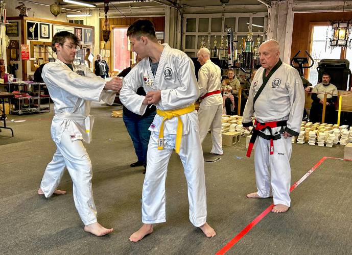 Nick Constantine, age 14, breaks boards at the Greenfield Tae Kwon Do Center’s annual “break-athon” on Sunday, where students raise money for the Greenfield Recorder’s Warm the Children charity.