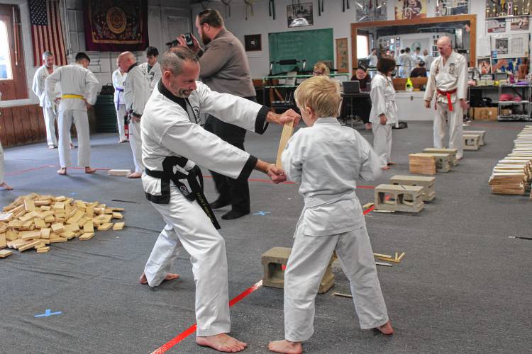 Nine-year-old Xavier Pouliot of Turners Falls breaks a board during the 21st annual “break-athon” fundraiser at the Greenfield Tae Kwon Do Center on Sunday.