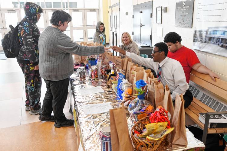 Students buy raffle tickets for treats and goods in the Greenfield High School cafeteria during lunch on Friday to raise money for the Wounded Warrior Project.
