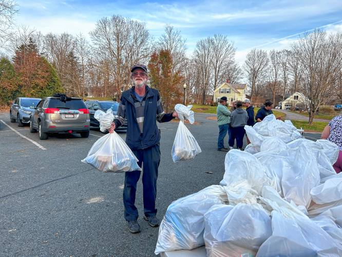 Ralph “Reggie” Gordon volunteers to give distribute Thanksgiving meals with Robert “Bobby C” Campbell at the Bernardston Senior Center on Friday.