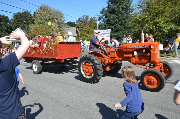 Children throw candy from a tractor during the parade for Conway’s 59th Festival of the Hills in October 2023.
