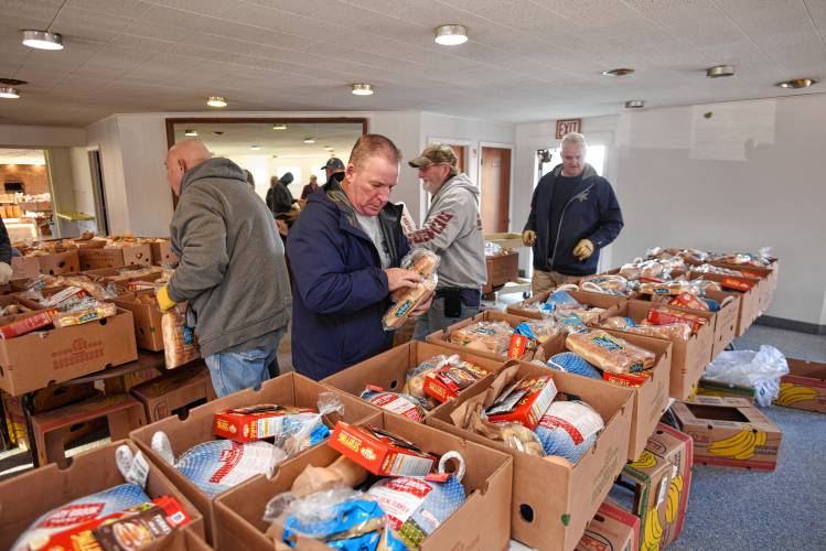 Members of the Thomas Memorial Golf & Country Club teamed up again with the Franklin County Sheriff’s Office TRIAD program to provide and assemble 150 complete Thanksgiving meals, from turkeys to pie, at the golf course in Turners Falls on Monday morning.