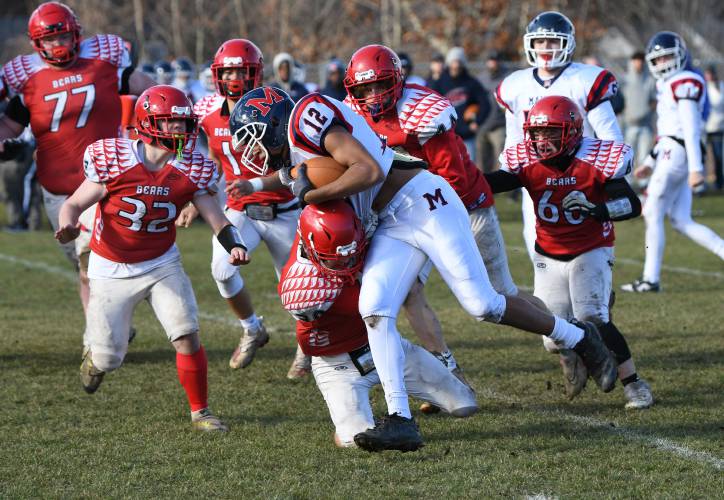 Mahar’s Malaki Grummell is tackled by a host of Athol defenders during the host Bears’ 40-8 victory at O’Brien Field on Thursday. 