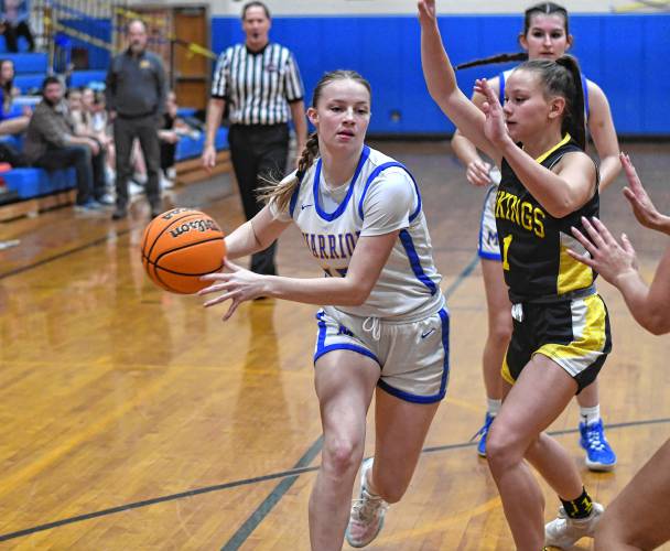 Mohawk Trail’s Rachel Pease drives the lane while defended by Smith Voc’s Caitlin Willard during the Warriors’ 46-23 victory in Buckland on Thursday night.