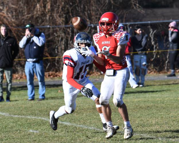 Athol’s Raydin Sousa pulls in a touchdown pass while coverd by Mahar’s Sean Ramos Jr. at O’Brien Field on Thursday. 