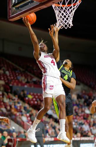 UMass guard Robert Davis Jr. (4) goes in for a layup before being fouled by South Florida’s Kobe Knox (4) in the first half Saturday at the Mullins Center in Amherst.