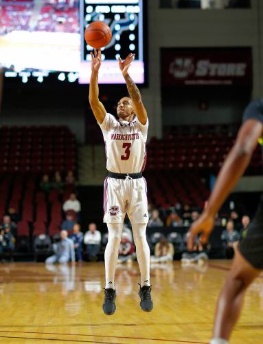 UMass guard Rahsool Diggins (3) hits a three-pointer against South Florida in the first half Saturday at the Mullins Center in Amherst.