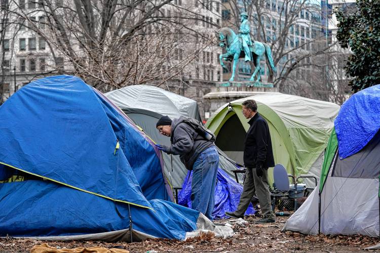 Homeless advocates check inside tents at McPherson Square in Washington D.C. in February 2023, prior to the clearing of the homeless encampment by the National Park Service.
