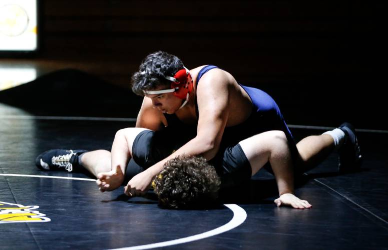 Frontier’s Javion Cabrera, top, competes against Smith Vocational’s Colin Pascal in the 285-pound weight class last week in Northampton. 
