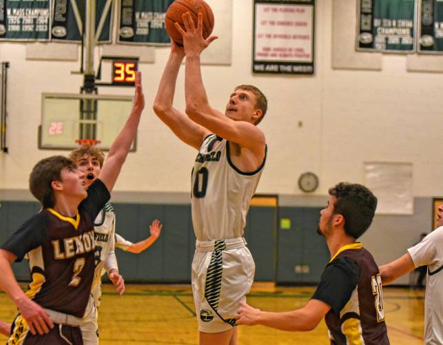 Greenfield’s Petru Cojocaru (10) puts a shot up over Lenox’s Chris Lyon (2) during the Green Wave’s Hampshire League South victory on Friday night at Nichols Gymnasium in Greenfield.