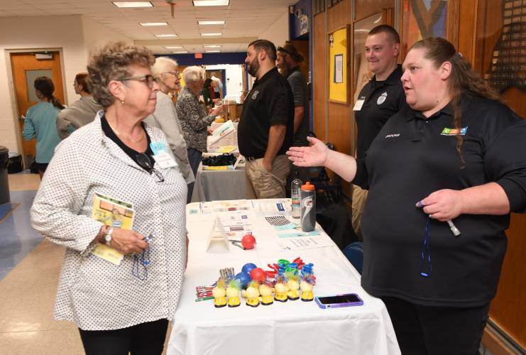 Jana Standish talks with Jessica Brooks, a co-responder with Clinical & Support Options, at the Shelburne Police Department’s booth at West County People Supporting People’s Community Resource Fair at Mohawk Trail Regional School last week.